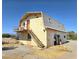 Two-story barn building with staircase and balcony, in need of repair and restoration at 1400 Silver Peak Ave, Pahrump, NV 89048