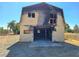 Damaged two-story barn building with boarded up windows needing repair after fire damage at 1400 Silver Peak Ave, Pahrump, NV 89048