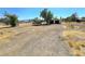 Expansive land and property featuring a dirt driveway and fence, presenting vast potential for development and customization at 1400 Silver Peak Ave, Pahrump, NV 89048
