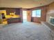 Cozy living room featuring a brick fireplace and an open layout to the kitchen at 1400 Silver Peak Ave, Pahrump, NV 89048