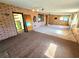 Open-concept space connecting water heater area and brick feature wall, showcasing renovation possibilities at 1400 Silver Peak Ave, Pahrump, NV 89048