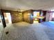 Spacious living room with a ceiling fan and open layout with view of the kitchen at 1400 Silver Peak Ave, Pahrump, NV 89048