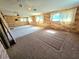 Large living room with panelled walls and natural light, offering renovation potential and space for gatherings at 1400 Silver Peak Ave, Pahrump, NV 89048