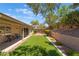 Backyard featuring low maintenance artificial turf, mature trees and shrubbery and covered patio at 1789 Castro Hill Ave, Henderson, NV 89012