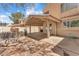 Backyard featuring covered patio, flagstone accents, custom seating, and landscaping at 1795 Nuevo Rd, Henderson, NV 89014