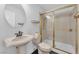 This tiled bathroom features a sink, toilet, and a shower with gold-trimmed glass doors, offering a classic design at 1795 Nuevo Rd, Henderson, NV 89014