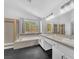 Bathroom with dual sinks, vanity lighting, a soaking tub, and a glass enclosed shower at 1795 Nuevo Rd, Henderson, NV 89014