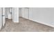 A clean bedroom featuring carpeted floors, a mirrored closet, and white trim at 1795 Nuevo Rd, Henderson, NV 89014