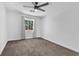 This bedroom has neutral carpet, is well-lit from a window, and is perfect for personalization at 1795 Nuevo Rd, Henderson, NV 89014