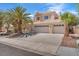 Spacious home with a three-car garage, tile roof, mature landscaping, and ample driveway parking at 1795 Nuevo Rd, Henderson, NV 89014