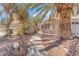 Inviting front entrance with a decorative wrought-iron gate and desert landscaping at 1795 Nuevo Rd, Henderson, NV 89014