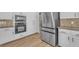 This kitchen features modern appliances, hardwood floors, and granite countertops at 1795 Nuevo Rd, Henderson, NV 89014