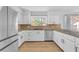 Bright kitchen features granite countertops, hardwood floors and stainless steel appliances at 1795 Nuevo Rd, Henderson, NV 89014