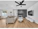 Open concept living room showcasing wood floors, a stone fireplace, and a view of the backyard at 1795 Nuevo Rd, Henderson, NV 89014