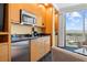 Compact kitchenette featuring a microwave, sink, and cabinets, with city views through the window at 2000 N Fashion Show Dr # 4318, Las Vegas, NV 89109