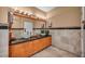 Community bathroom with granite countertop, vessel sinks, and travertine tile at 2200 S Fort Apache Rd # 2041, Las Vegas, NV 89117