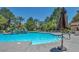 Resort-style community pool with lush landscaping, waterfall feature, and plenty of lounge seating at 2200 S Fort Apache Rd # 2041, Las Vegas, NV 89117