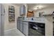 Galley kitchen featuring gray cabinets, gray backsplash, stainless steel appliances, and tiled floors at 2200 S Fort Apache Rd # 2041, Las Vegas, NV 89117
