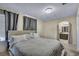 Bedroom featuring a queen sized bed, wall to wall carpeting, gray curtains, and an arched doorway at 2200 S Fort Apache Rd # 2041, Las Vegas, NV 89117