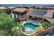 Aerial view of backyard with a pool, spa, covered patio, and solar panels at 2333 Indigo Island St, Henderson, NV 89044