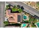 Overhead shot of a backyard oasis featuring a pool, spa, covered patio, and lush landscaping at 2333 Indigo Island St, Henderson, NV 89044