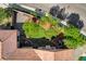 Overhead view of the backyard featuring lush greenery, stone pathways, and mature trees at 2333 Indigo Island St, Henderson, NV 89044