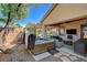 Backyard patio featuring a hot tub and an outdoor seating area, with a TV under the covered area at 2333 Indigo Island St, Henderson, NV 89044