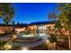 A serene backyard with a pool, hot tub, lush landscaping, patio, and outdoor seating at 2333 Indigo Island St, Henderson, NV 89044