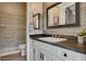 Bathroom featuring a tile shower and a modern vanity with a dark countertop at 2333 Indigo Island St, Henderson, NV 89044