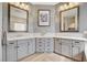 Elegant bathroom featuring dual sinks, gray cabinetry, modern lighting, and stylish mirrors, creating a spa-like ambiance at 2333 Indigo Island St, Henderson, NV 89044