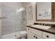 Modern bathroom features tile shower, glass door, and vanity with a dark countertop at 2333 Indigo Island St, Henderson, NV 89044