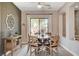 Cozy dining room featuring a round wooden table and chairs, complemented by a stylish buffet and neutral tones at 2333 Indigo Island St, Henderson, NV 89044