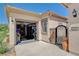 Tan single story home featuring a two-car garage and gated front courtyard at 2333 Indigo Island St, Henderson, NV 89044