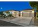A home with an attached two-car garage, well-lit exterior, and landscaped front yard at 2333 Indigo Island St, Henderson, NV 89044