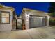 Attached two-car garage, gated courtyard entry, and manicured landscaping enhance this home's curb appeal at 2333 Indigo Island St, Henderson, NV 89044