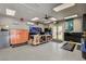 View of a spacious garage with a workbench, cabinets, ceiling fan and epoxy flooring at 2333 Indigo Island St, Henderson, NV 89044