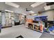View of a spacious garage featuring epoxy floors, workbenches and tool storage at 2333 Indigo Island St, Henderson, NV 89044