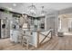 Bright, modern kitchen features a large island, stainless steel appliances, and stylish pendant lighting at 2333 Indigo Island St, Henderson, NV 89044