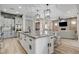 Open-concept kitchen and living room with island seating and hardwood-style floors at 2333 Indigo Island St, Henderson, NV 89044