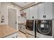 Laundry room featuring gray cabinets, a sink, and modern stainless steel washer and dryer at 2333 Indigo Island St, Henderson, NV 89044