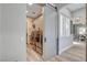 Modern laundry room with stainless steel washer and dryer behind a sliding barn door at 2333 Indigo Island St, Henderson, NV 89044