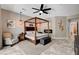 Stylish main bedroom with a four-poster bed, sitting area, and elegant decor, creating a relaxing retreat at 2333 Indigo Island St, Henderson, NV 89044