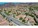 Areal view showcasing a community with many single-Gathering homes, mountain views, and manicured streets at 2333 Indigo Island St, Henderson, NV 89044