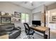 This home office features a desk, a reading chair, and decor on the walls at 2333 Indigo Island St, Henderson, NV 89044