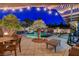 Outdoor living space with a patio, outdoor furniture, lush landscaping and a beautiful pool at 2333 Indigo Island St, Henderson, NV 89044