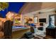 Outdoor living area features a hot tub, comfortable seating, and cozy outdoor fireplace at 2333 Indigo Island St, Henderson, NV 89044