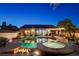 Stunning backyard features a sparkling pool and spa, perfect for outdoor entertaining at dusk at 2333 Indigo Island St, Henderson, NV 89044