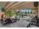 Outdoor kitchen and dining area that features a pool, spa, and beautiful landscaping at 2333 Indigo Island St, Henderson, NV 89044