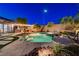 Inviting backyard pool and spa area with lush landscaping and ambient lighting at 2333 Indigo Island St, Henderson, NV 89044