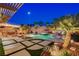 Backyard pool and spa area with lush landscaping, patio, BBQ and outdoor dining set at 2333 Indigo Island St, Henderson, NV 89044